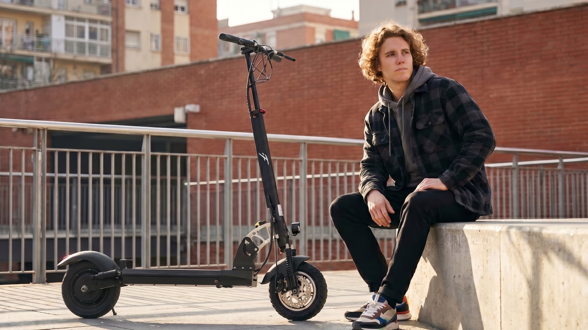 F1 Scooters rider resting on a concrete bench next to a folding commuter scooter in a sunlit urban neighborhood